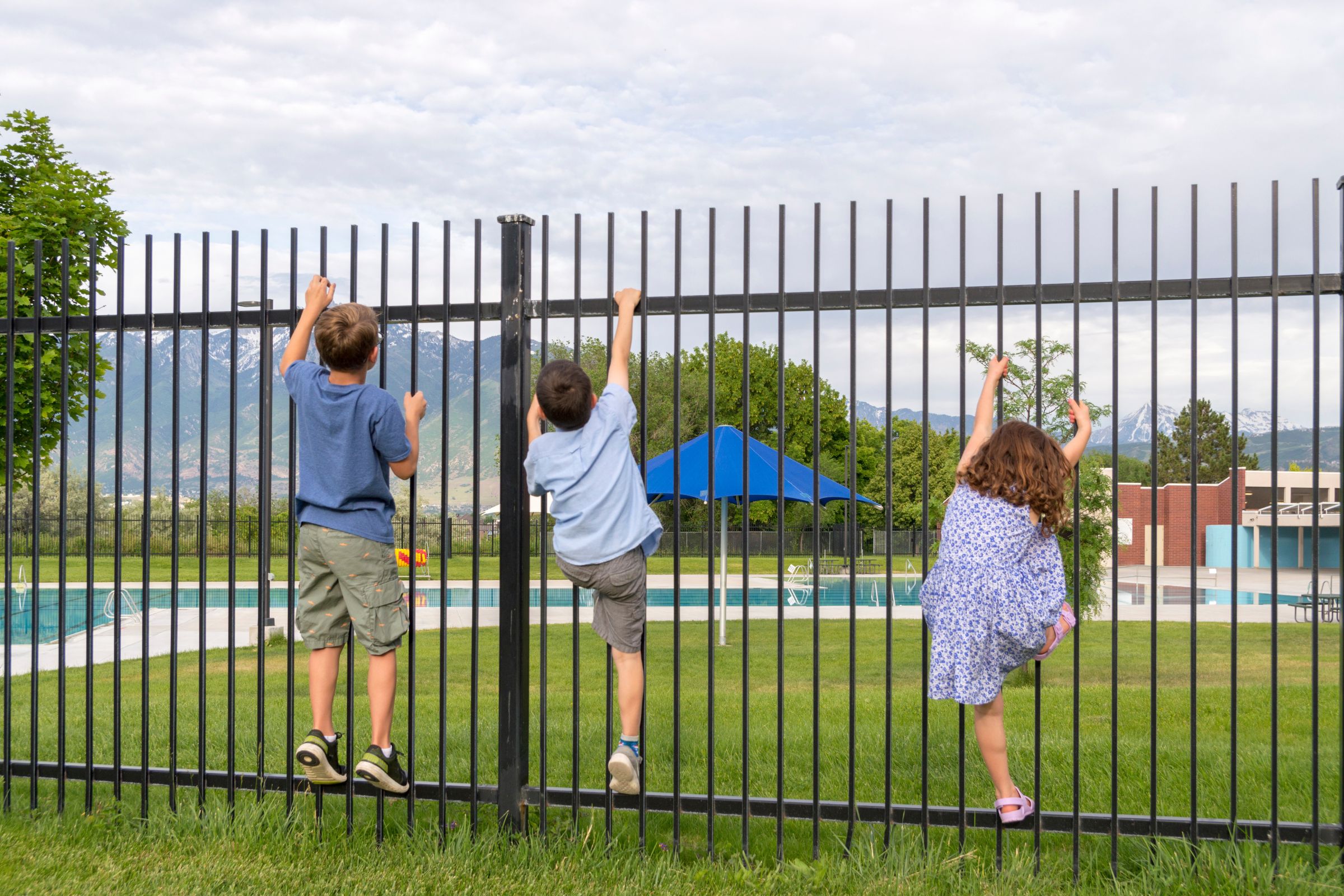 kids climbing pool fence