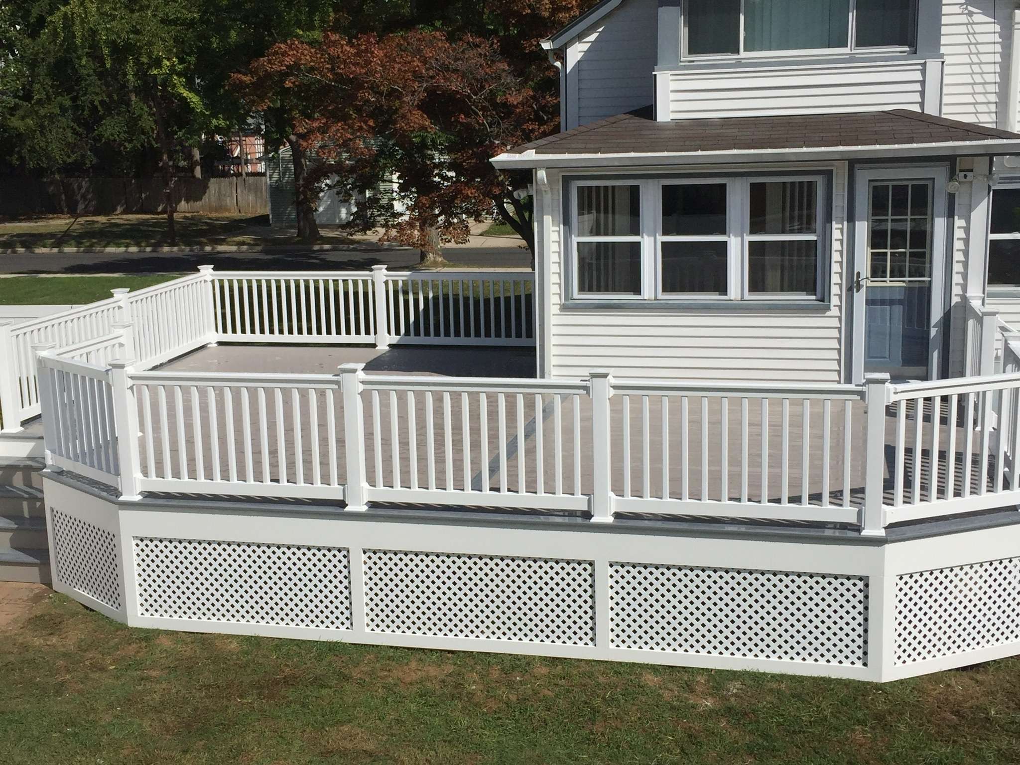 Two-Toned Deck With White Vinyl Railing and Lattice Facing